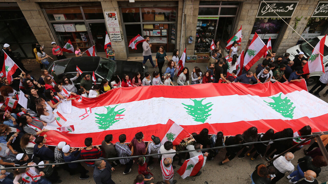 Demonstrators carry Lebanese flags during an anti-government protest in the mainly Druze town of Hasbaya, Lebanon October 25, 2019. REUTERS/Aziz Taher - RC1D8675FAA0