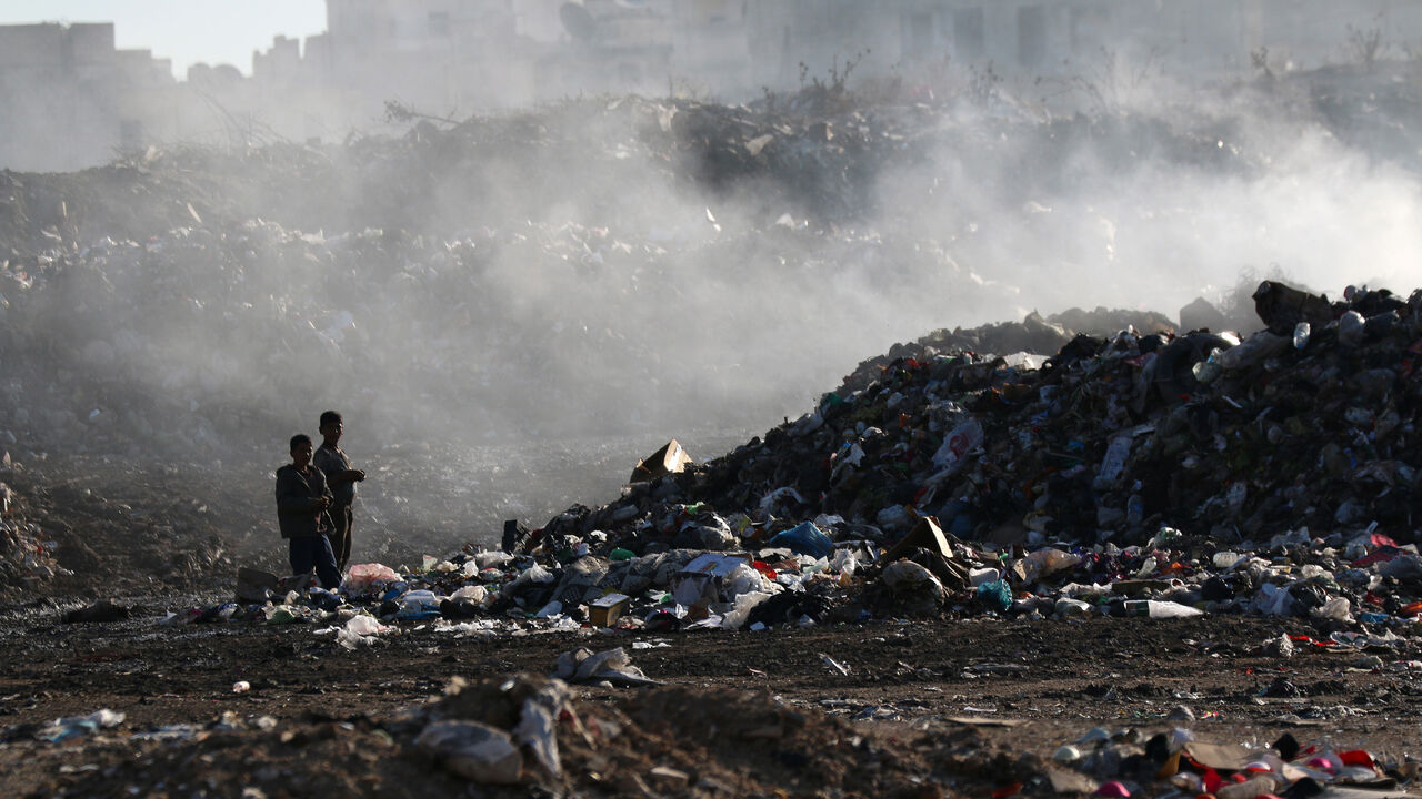 Syrian children sift through garbage at a landfill in the rebel-held part of the northern city of Aleppo, on October 27, 2015. According to UNICEF, more than 2.6 million children from war-ravaged Syria are out of school, sparking fears of a "lost generation." AFP PHOTO / FADI AL-HALABI / AFP / AMC / Fadi al-Halabi        (Photo credit should read FADI AL-HALABI/AFP via Getty Images)