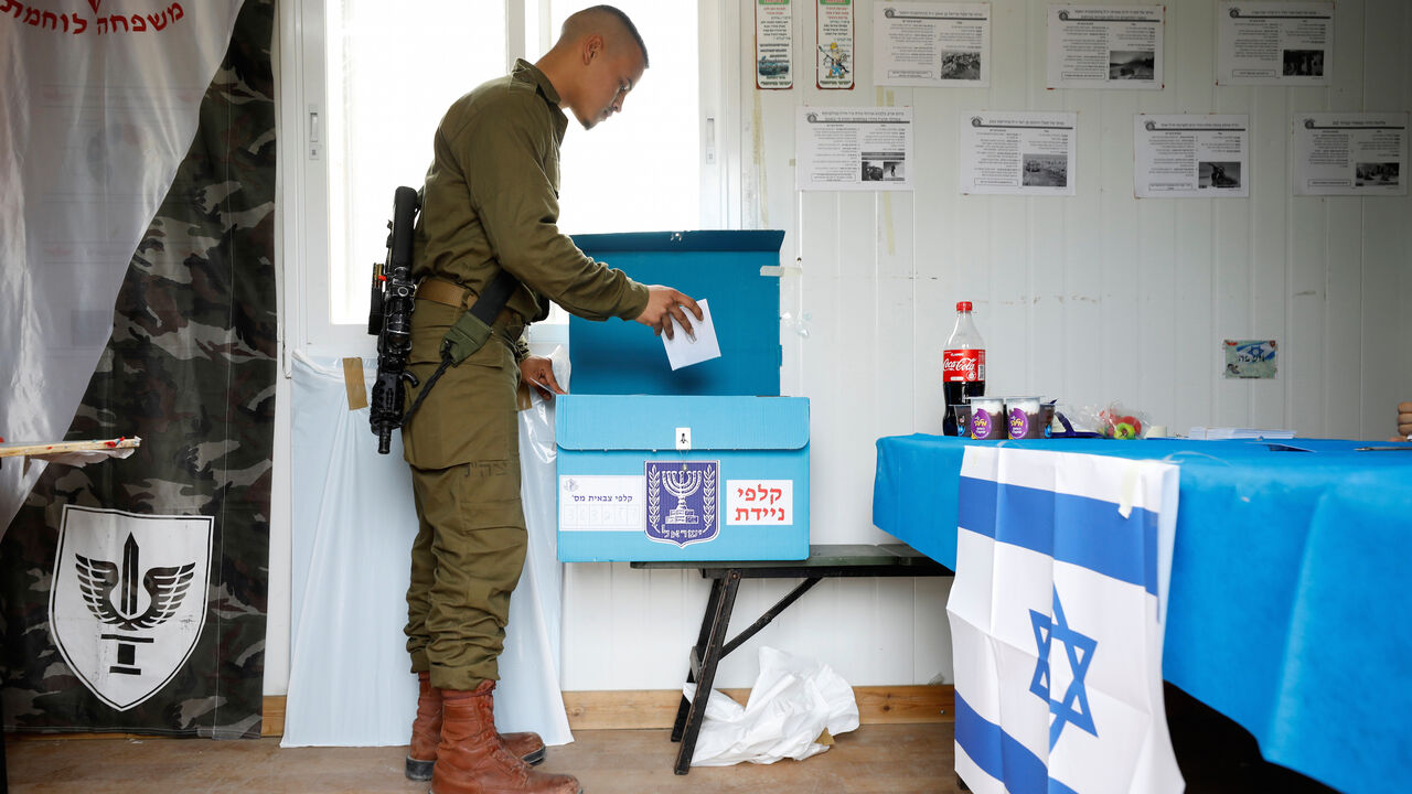 An Israeli soldier casts his ballot as he votes in Israel's national election in a mobile polling station at a military post outside the northern Gaza Strip, in southern Israel March 2, 2020. REUTERS/Amir Cohen - RC2NBF9S65NP