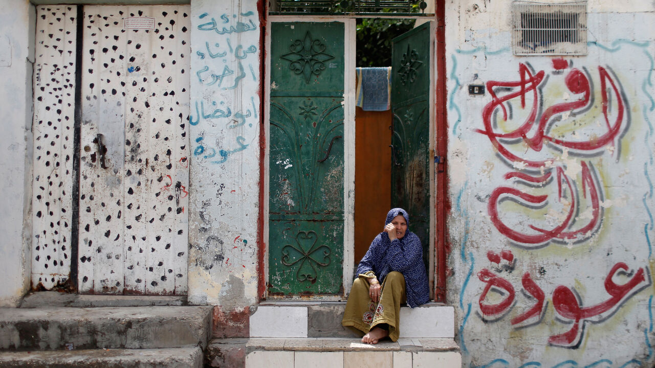 A Palestinian woman sits outside her home in Jabalia refugee camp, one of the most densely populated areas in the world, amid concerns about the spread of the coronavirus disease (COVID-19), in the northern Gaza Strip May 5, 2020. REUTERS/Mohammed Salem - RC2CIG93IB6K