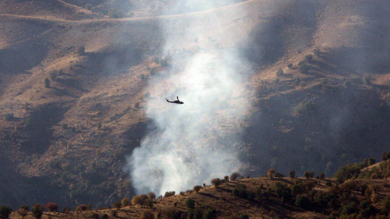 Turkish helicopters fly over the Cudi mountain during an attack on an outlawed Kurdistan Workers Party (PKK) camp 30 October 2007 in the Cudi mountains, Sirnak province, near the Turkish-Iraqi border, south-eastern Turkey. Iraqi Kurdish leader Massud Barzani has urged Turkish Kurd rebels to renounce violence, but insisted he will take no "orders" from Turkey to crack down on their bases in the autonomous northern Iraqi region he administers. AFP PHOTO / MUSTAFA OZER (Photo credit should read MUSTAFA OZER/AF