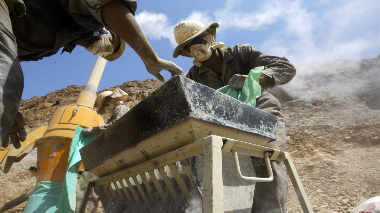 Egyptian workers manipulate mineral samples from a gold mine at Marsa Alam, in the Red Sea hills, 14 September 2006. After a 2,000-year lapse, Egypt is looking to acquire a gold-mining industry again by reviving ancient deposits of the precious mineral that symbolised the glory of the Pharaohs. AFP PHOTO/KHALED DESOUKI (Photo credit should read KHALED DESOUKI/AFP via Getty Images)