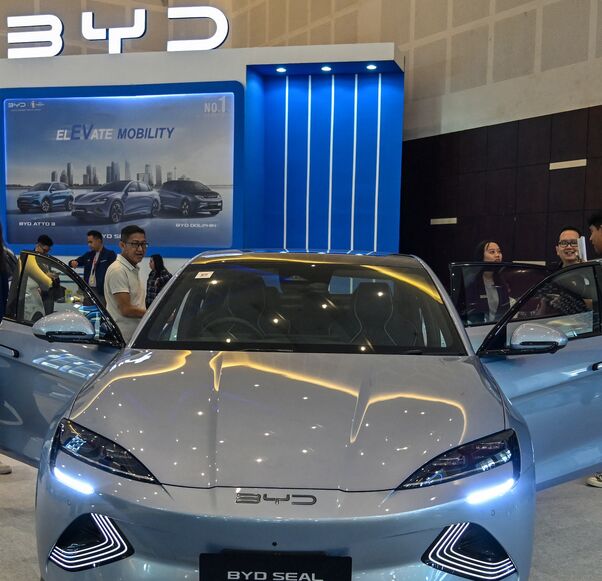 People visit the booth of Chinese automobile manufacturer BYD during the Indonesia International Motor Show in Surabaya on May 29, 2024. 