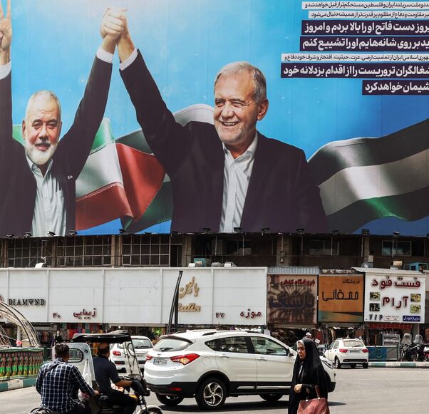 A woman walks amid vehicles next to a billboard of Iranian President Masoud Pezeshkian (R) and late Hamas leader Ismail Haniyeh at the Valise square in Tehran, on August 1, 2024.