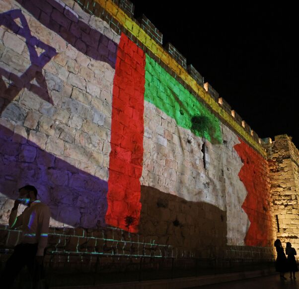 The flags of Israel, United Arab Emirates, and Bahrain are projected on the ramparts of Jerusalem's Old City on September 15, 2020 in a show of support for Israeli normalisation deals with the United Arab Emirates and Bahrain. - Israeli Prime Minister Benjamin Netanyahu signed landmark accords normalizing the Jewish state's relations with the United Arab Emirates and Bahrain, as part of a peace push brokered by US President Donald Trump. (Photo by Menahem KAHANA / AFP) (Photo by MENAHEM KAHANA/AFP via Getty