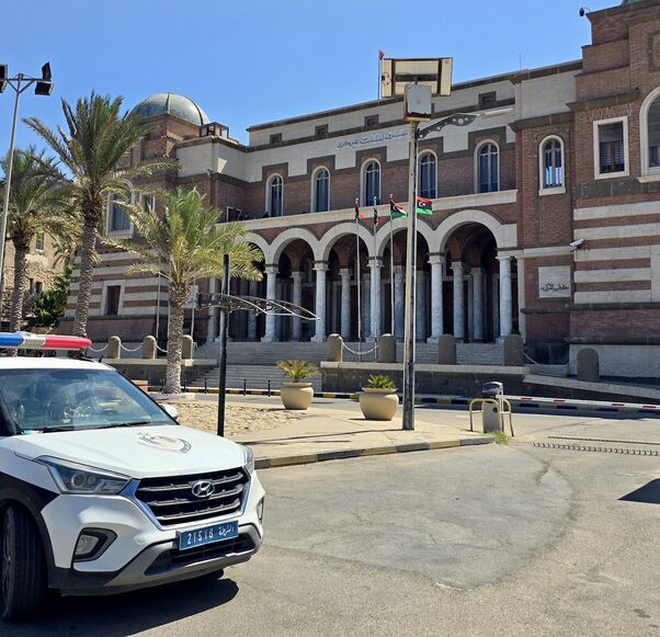 Police officers stand guard outside Libya's Central Bank headquarters in Tripoli on Aug. 27, 2024. 