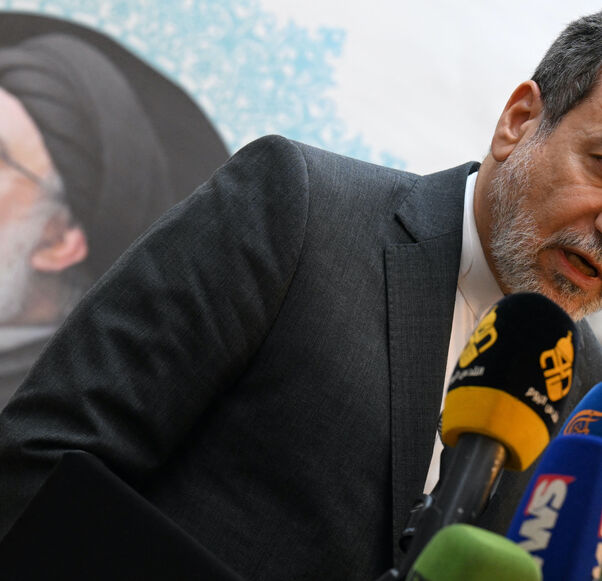 Iranian Foreign Minister Abbas Araghchi speaks to the press, in front of the portrait of slain Lebanese Hezbollah leader Hassan Nasrallah, after meeting with Syrian officials at the Iranian embassy in Damascus on Oct. 5, 2024. 