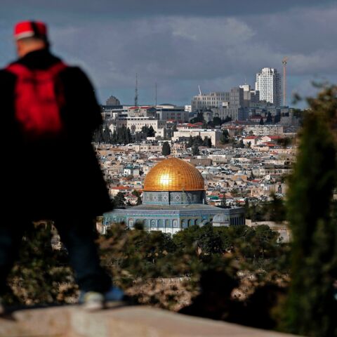 A picture taken from the Mount of Olives on Jan. 20, 2018, shows a Muslim tourist viewing Jerusalem's Old City and the Dome of the Rock. 