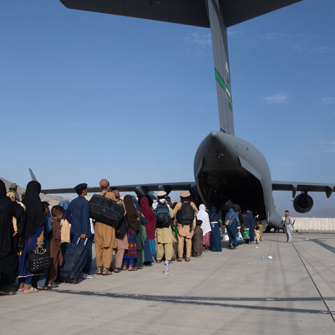 In this handout provided by U.S. Central Command Public Affairs, U.S. Air Force loadmasters and pilots assigned to the 816th Expeditionary Airlift Squadron, load passengers aboard a U.S. Air Force C-17 Globemaster III in support of the Afghanistan evacuation at Hamid Karzai International Airport (HKIA) on Aug. 24, 2021 in Kabul, Afghanistan. 