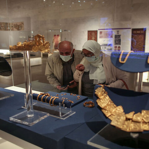 Visitors look at displayed ancient jewelry during its official reopening a day after the Pharaohs' Golden Parade ceremony, National Museum of Egyptian Civilization, Cairo, Egypt, April 4, 2021.