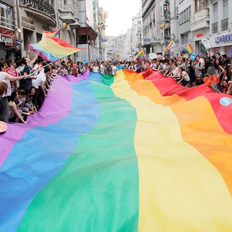 People hold a giant rainbow flag during a parade on Istiklal Street.