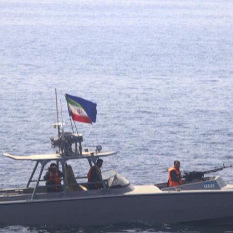 In this photo made available by the US Navy, a boat of Iran's Islamic Revolutionary Guard Corps Navy operates in close proximity to patrol coastal ship USS Sirocco.