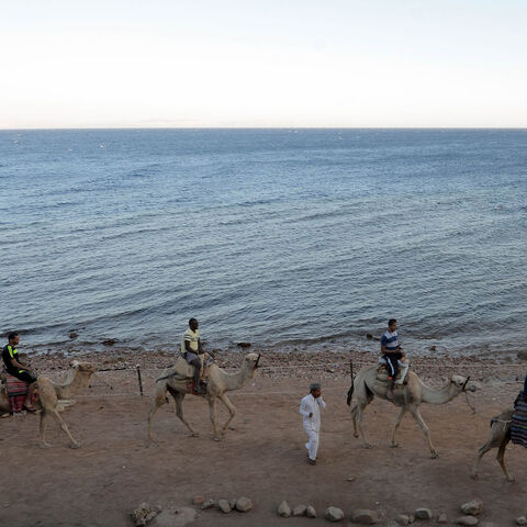 Tourists ride camels on the shores of the town of Dahab, southern Sinai Peninsula, Egypt, May 12, 2017.