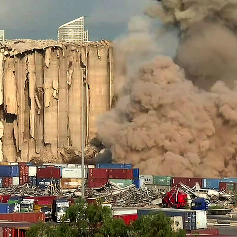 Smoke plume rising after the new collapse of the northern section of the grain silos at the port of Lebanon's capital Beirut, which were previously partly destroyed by the 2020 port explosion. (Photo by DYLAN COLLINS/AFPTV/AFP via Getty Images)