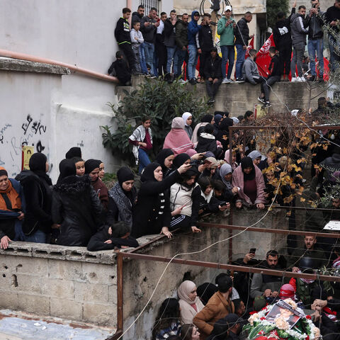 Mourners attend the funeral of Omar Khmour, 14, in the Dheisheh refugee camp, Bethlehem, West Bank, Jan. 16, 2023.