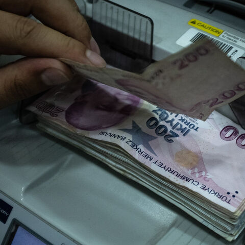 A man counts Turkish liras at a currency exchange office, Istanbul, Turkey, July 29, 2020.