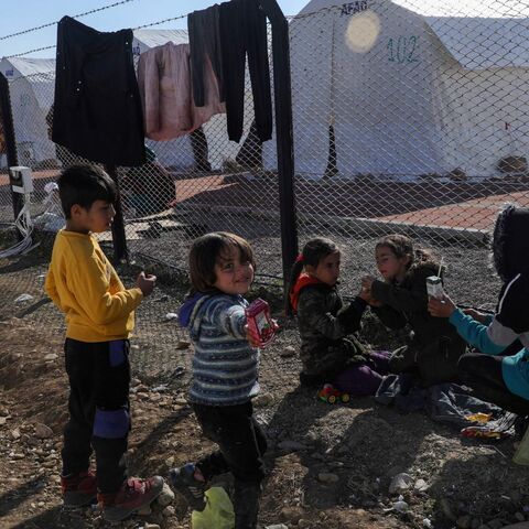 Quake-hit displaced children play near tents set by Turkey's Disaster and Emergency Management Presidency (AFAD) at Islahiye Atatürk Stadium in Islahiye near Gaziantep on Feb. 14, 2023, a week after a deadly earthquake struck parts of Turkey and Syria. 