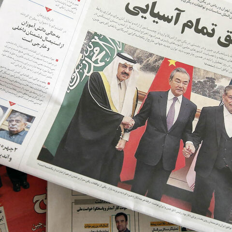 A man in Tehran holds a local newspaper reporting on its front page the China-brokered deal between Iran and Saudi Arabia to restore ties, signed in Beijing the previous day, March 11, 2023.