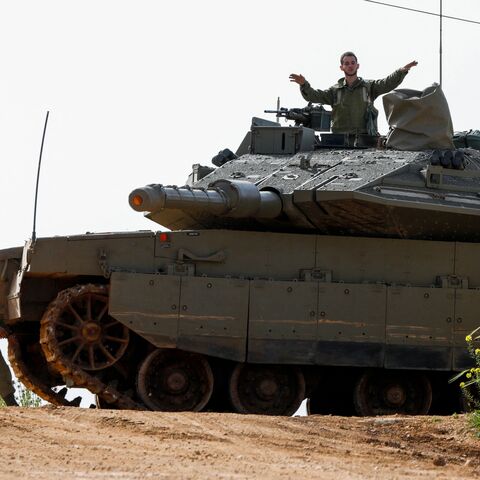 TOPSHOT - Israeli soldiers take up a position with a tank near Shtula, bordering Lebanon, on April 7, 2023. - Israel launched air strikes before dawn on April 7 in the Gaza Strip and Lebanon, saying it was targeting Palestinian militant group Hamas in retaliation for several dozen rockets fired at Israel from both territories. (Photo by Jalaa MAREY / AFP) (Photo by JALAA MAREY/AFP via Getty Images)