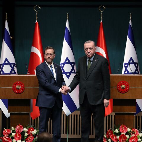 Israeli President Isaac Herzog (L) and his Turkish counterpart Tayyip Erdogan shake hands during a press conference in Ankara, on March 9, 2022. (Photo by AFP) (Photo by STR/AFP via Getty Images)