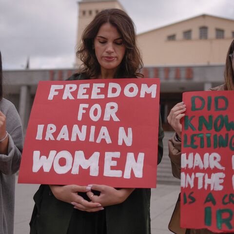 Women take part in a rally in support of Iranian women in Pristina on Oct. 12, 2022.