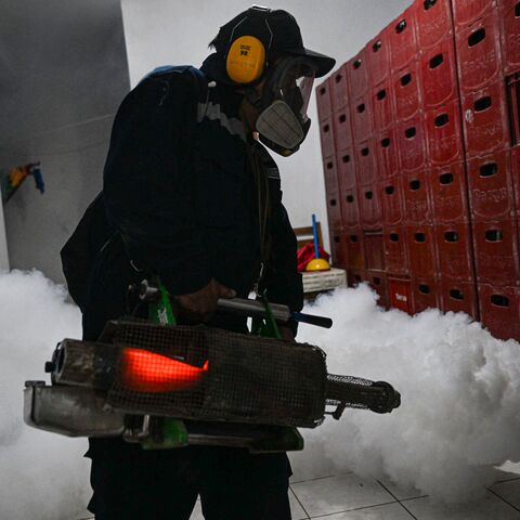 A worker fumigates a house against the Aedes aegypti mosquito to prevent the spread of dengue fever in a neighborhood in Piura, northern Peru, on June 11, 2023. (Photo by ERNESTO BENAVIDES / AFP) (Photo by ERNESTO BENAVIDES/AFP via Getty Images)