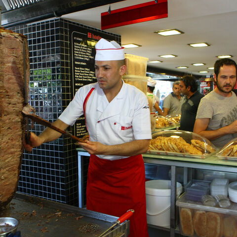 This photo taken on July 10, 2012, in Ankara shows people at a traditional "doner" fast food restaurant. In Turkey 35% of the population has accumulated excess body fat to the extent that it may have an adverse effect on health, leading to reduced life expectancy and/or increased health problems. The Turkish health ministry has launched a campaign calling on Turks to be more active. AFP PHOTO/ADEM ALTAN (Photo credit should read ADEM ALTAN/AFP/GettyImages)