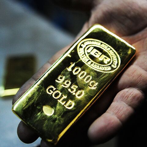 A gold worker holds a 1 KG gold bullion at Istanbul Gold Refinery (IGR) on January 13, 2015 in Istanbul. 