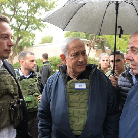 In this handout image provided by the GPO, Israel's Prime Minister Benjamin Netanyahu (C) takes Elon Musk (L) on a tour of Kibbutz Kfar Aza after the Oct. 7 massacre took place there, on Nov. 27, 2023 in Kfar Aza, Israel.  