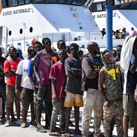 Migrants of African origin trying to flee to Europe, disembark in Sfax from a ship owned by the Tunisian coast guards, after being intercepted by them at sea on August 10, 2023. 