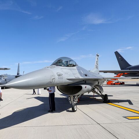 A man walks past a US Air Force (USAF) General Dynamics F-16 Fighting Falcon multirole fighter aircraft during the 2023 Dubai Airshow at Dubai World Central - Al-Maktoum International Airport in Dubai on November 13, 2023. (Photo by Giuseppe CACACE / AFP) (Photo by GIUSEPPE CACACE/AFP via Getty Images)