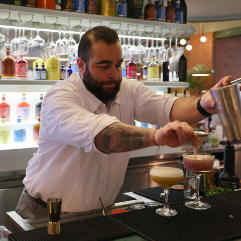 Lebanese bartender Hadi Ghassan prepares a drink behind the counter at "Meraki Riyadh", a pop-up bar offering non-alcoholic bellinis and spritzes, served in chilled cocktail glasses, in Riyadh on January 23, 2024. The bar's success highlights widening acceptance of more daring non-alcoholic fare even as booze itself remains strictly off-limits in the Gulf kingdom, home to Islam's holiest sites. (Photo by Fayez Nureldine / AFP) (Photo by FAYEZ NURELDINE/AFP via Getty Images)