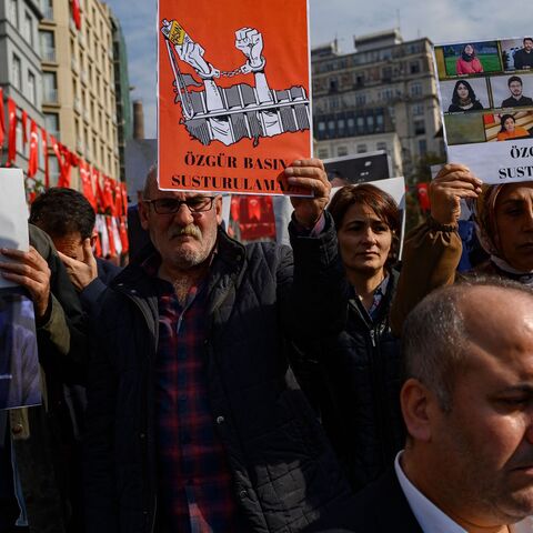 People take part in a protest against the arrest of nine journalists working for Kurdish media outlets including Mezopotamya news agency in Istanbul, on Oct. 31, 2022. 