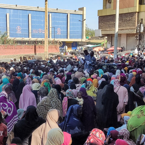 People from states of Khartoum and al-Jazira, displaced by the ongoing conflict in Sudan between the army and paramilitaries, queue to receive aid from a charity organisation in Gedaref on December 30, 2023. (Photo by AFP) (Photo by -/AFP via Getty Images)
