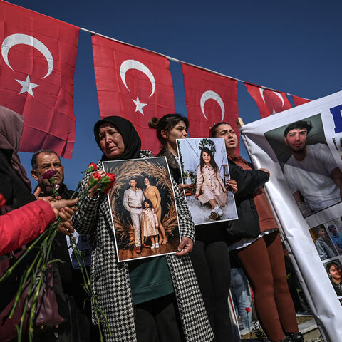 Relatives of missing persons hold placards and a banner with their portraits at the Hatay Earthquake Martyrs Cemetery, during a gathering marking the first anniversary of a powerful earthquake that hit the region, in Antakya, southern Turkish Hatay Province, on Feb. 6, 2024. 