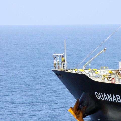 In this handout photo provided by the U.S. Navy, suspected pirates indicate their surrender with a white cloth on the bow of the Japanese-owned commercial oil tanker M/V Guanabara March 6, 2011 in the Arabian Sea. 