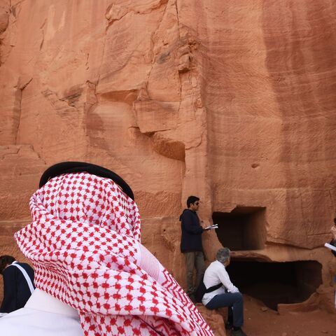 A picture taken on March 31, 2018 shows a Saudi man standing at the entrance of a tomb at Madain Saleh, a UNESCO World Heritage site, near Saudi Arabia's northwestern town of al-Ula. - Al-Ula, an area rich in archaeological remnants, is seen as a jewel in the crown of future Saudi attractions as the austere kingdom prepares to issue tourist visas for the first time -- opening up one of the last frontiers of global tourism. Saudi Crown Prince Mohammed bin Salman is set to sign a landmark agreement with Paris
