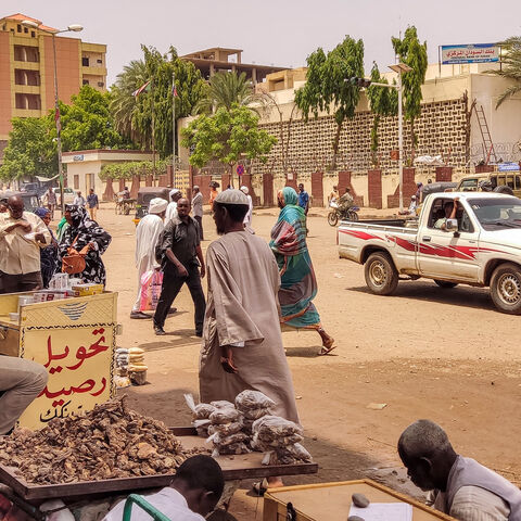 Pedestrians and vehicles move along a road outside a branch of the central bank, in the eastern city of Gedaref, Sudan, July 9, 2023.
