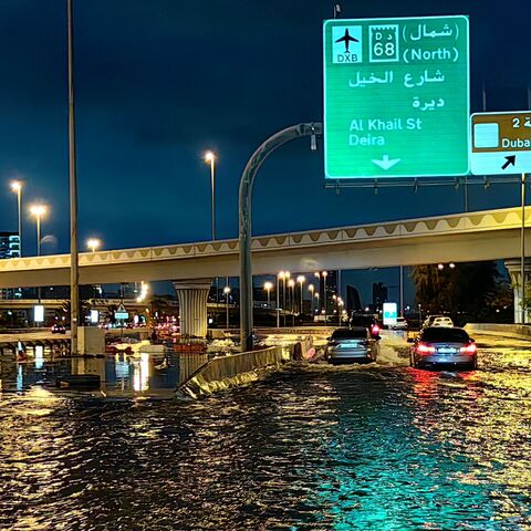 Motorists drive along a flooded street following heavy rains in Dubai early on April 17, 2024. 