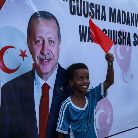 A Somali boy holds a Turkish national flag as people celebrate the victory of Turkish President Recep Tayyip Erdogan after he won the presidential run-off election in Mogadishu, on May 29, 2023. (Photo by Hassan Ali Elmi / AFP) (Photo by HASSAN ALI ELMI/AFP via Getty Images)