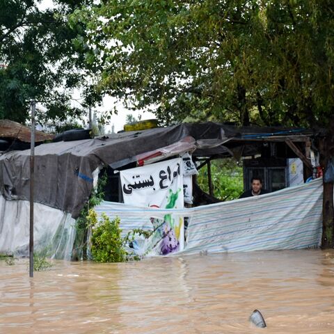 A man looks from a shack surrounded by heavy flooding in Iran's northwestern city of Astara, Gilan province, after severe floods hit the northern part of the country, Sept. 18, 2023. 
