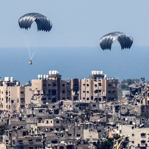 This picture taken from Israel's southern border with the Gaza Strip shows parachutes of humanitarian aid dropping over the besieged Palestinian territory on March 26, 2024, amid the ongoing conflict between Israel and the militant group Hamas. 