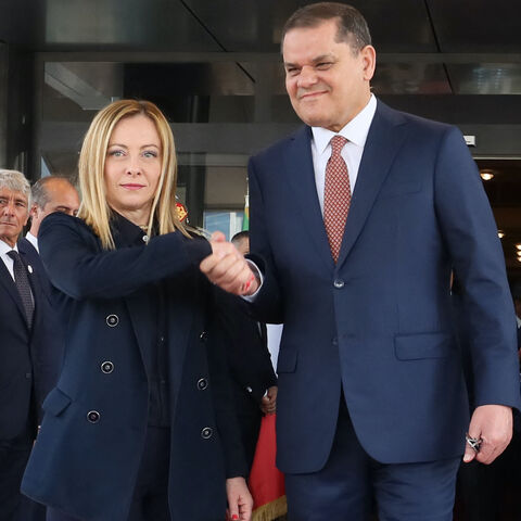 Libya's interim Prime Minister Abdulhamid Dbeibah (R) welcomes Italy's Prime Minister Giorgia Meloni as she arrives for a meeting in Tripoli on May 7, 2024. 