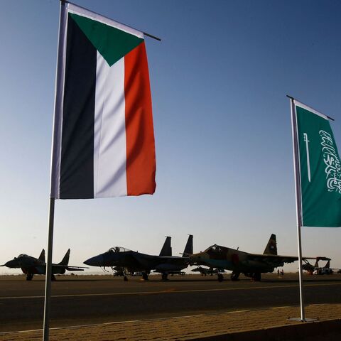 The Sudanese (L) and Saudi flag are seeing flying on the tarmac during a joint Sudan and Saudi Arabia air force drill at the Marwa air base, near Meroe some 350 kilometres north of Khartoum, on April 9, 2017.