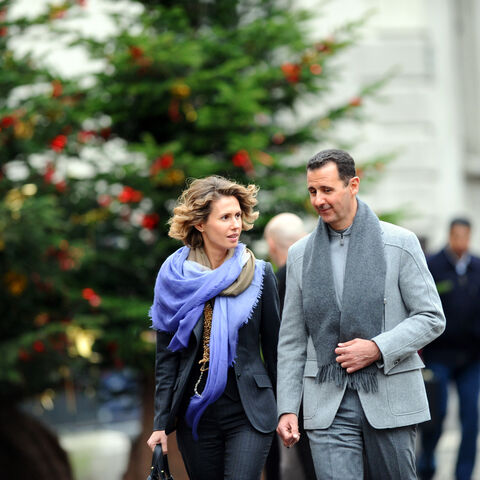 Syrian president Bashar al-Assad and his wife Asma walk in a street of Paris on December 10, 2010. Al-Assad is on a two-days official visit to France. AFP PHOTO MIGUEL MEDINA (Photo credit should read MIGUEL MEDINA/AFP via Getty Images)