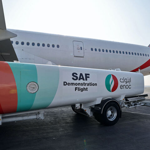 Ground crews prepare an Emirates Boeing 777-300ER aircraft, powering one of its engines with a hundred per cent Sustainable Aviation Fuel (SAF), for a demonstration flight at the Dubai International Airport in Dubai, on January 30, 2023. - Emirates said it successfully flew a Boeing 777 powered by sustainable aviation fuel today, as the Middle East's largest airline aims to halve its jet fuel consumption. The Dubai-based carrier has used sustainable aviation fuel (SAF) since 2017, but said its test flight w