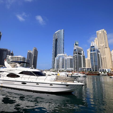 Boats are anchored in the Dubai Creek surrounded by high-rise buildings in the Gult emirate, on February 18, 2023. Home to towering skyscrapers and ultra-luxury villas, Dubai saw record real estate transactions in 2022, largely due to an influx of wealthy investors.