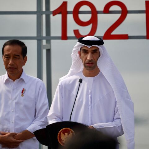 Indonesian President Joko Widodo (L) listens to a speech by United Arab Emirates (UAE) Minister of State for Foreign Trade Thani Ahmed Al Zeyoudi (R) during the inauguration of the newly built floating solar power plant on the water that can generate 192 mega watts of peak electricity in cooperation between the Indonesian government and Masdar from the UAE, at Cirata Reservoir, West Java, on November 9, 2023. (Photo by BAY ISMOYO / AFP) (Photo by BAY ISMOYO/AFP via Getty Images)