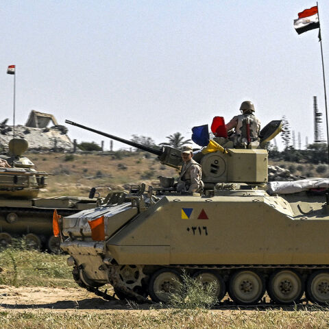 An Egyptian army M60 main battle tank and an infantry fighting vehicle (IFV) are deployed near the Egyptian side of the Rafah border crossing with the Gaza Strip on March 23, 2024, amid the ongoing conflict in the Palestinian territory between Israel and the Palestinian militant group Hamas. 