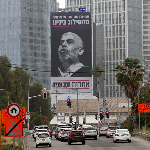 Cars drive past a billboard bearing an inscription in Hebrew which reads 'think well of who benefits from our division - unity now', with a portrait of the head of the political wing of the Palestinian Hamas movement in the Gaza Strip Yahya Sinwar, in Tel Aviv on April 26, 2024, amid the ongoing conflict between Israel and the Palestinian militant group Hamas in the Palestinian territory. (Photo by JACK GUEZ / AFP) (Photo by JACK GUEZ/AFP via Getty Images)